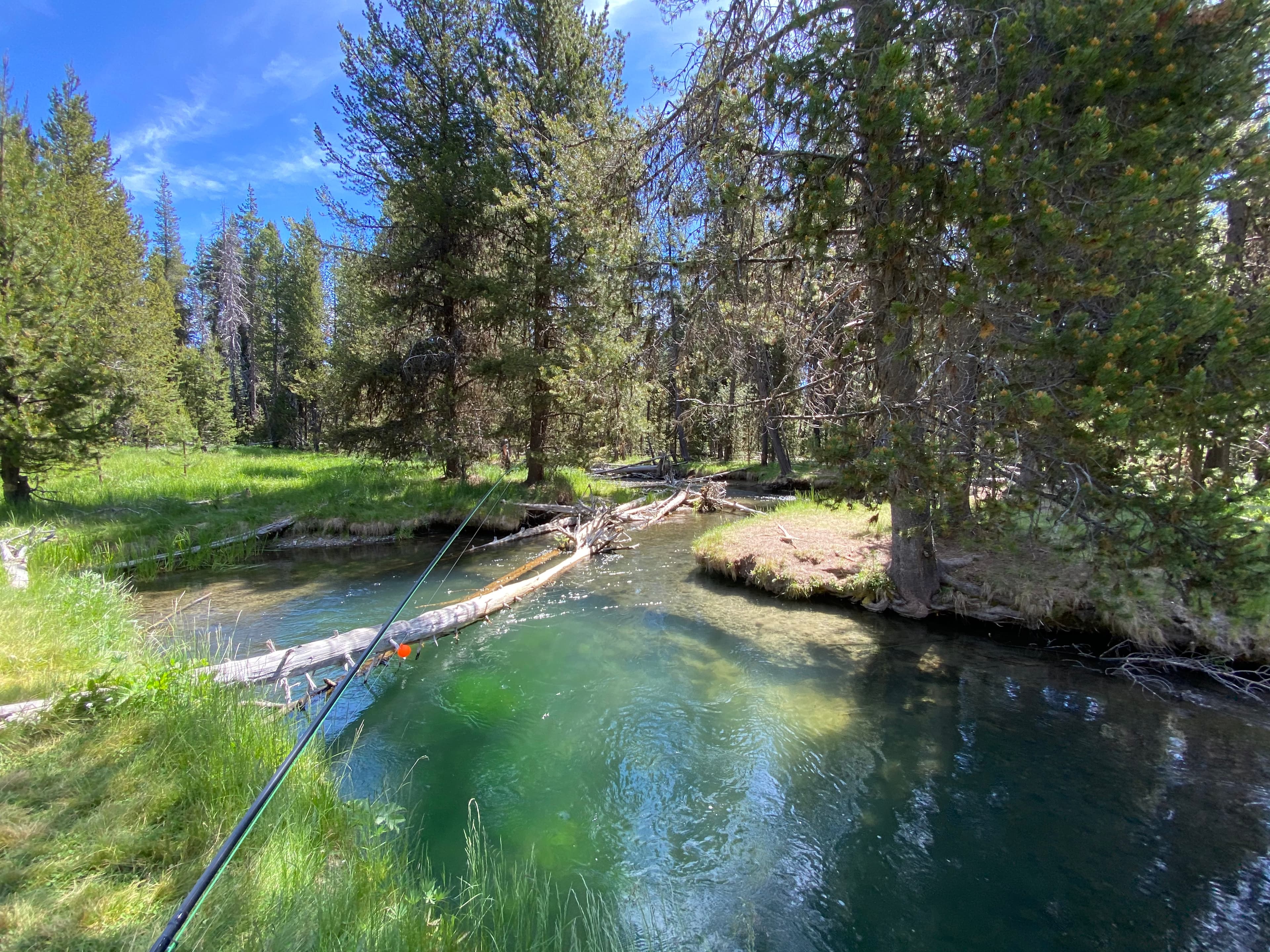 Fly rod over a clear river in the Oregon backcountry
