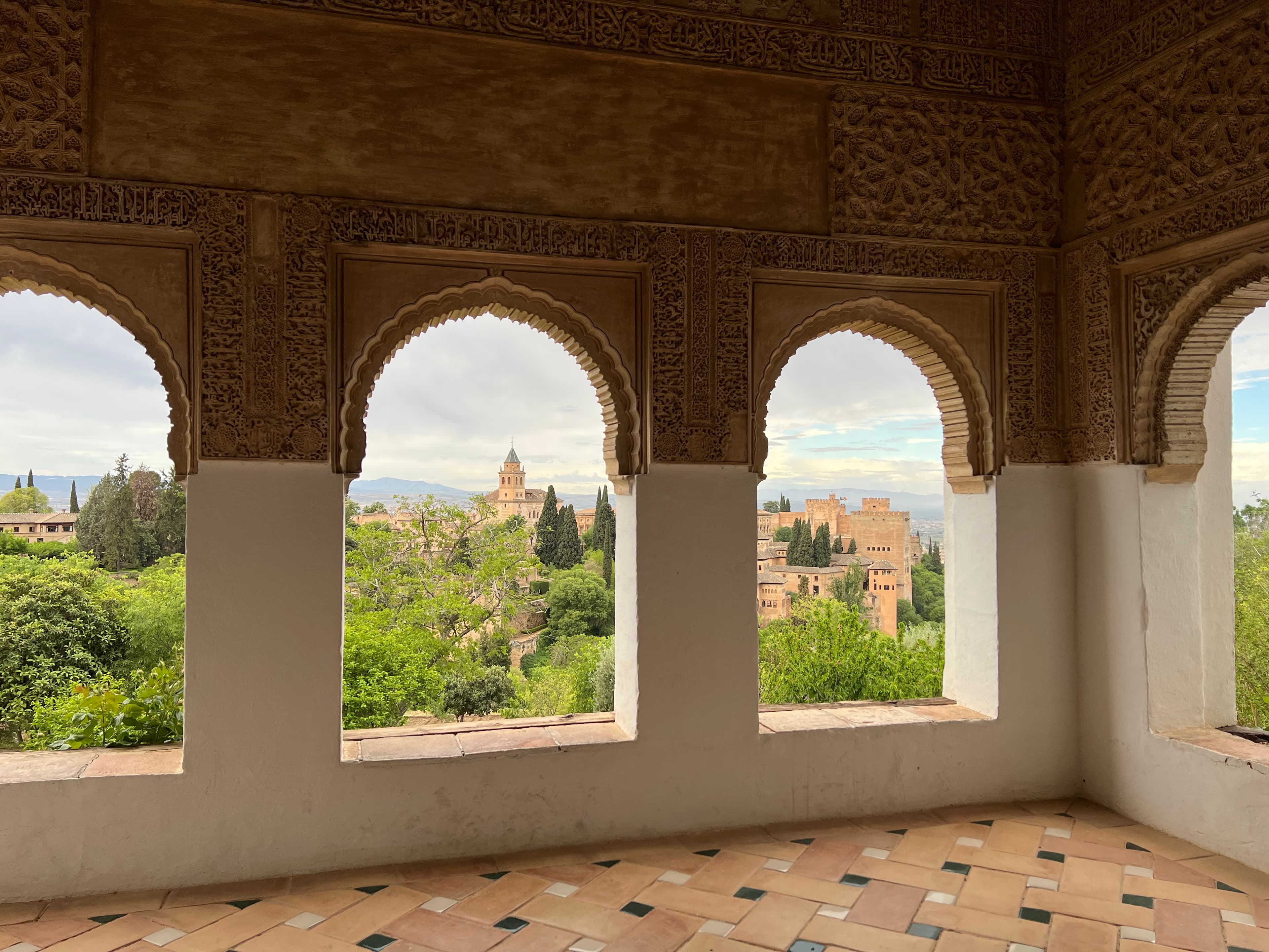 Moorish arches and carved plasterwork overlooking the Alhambra palace complex